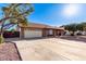 Charming home featuring an attached garage, fenced yard, and well-maintained landscaping at 4323 W Villa Theresa Dr, Glendale, AZ 85308