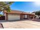 Charming home featuring an attached garage, fenced yard, and well-maintained landscaping at 4323 W Villa Theresa Dr, Glendale, AZ 85308