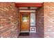 Inviting front entrance featuring a brick facade, decorative door, and sidelight window at 4323 W Villa Theresa Dr, Glendale, AZ 85308