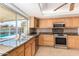 Well-equipped kitchen featuring oak cabinets, granite countertops, and stainless steel appliances at 4323 W Villa Theresa Dr, Glendale, AZ 85308