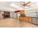 Bright kitchen with access to the living room, featuring oak cabinets and modern appliances at 4323 W Villa Theresa Dr, Glendale, AZ 85308