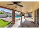 Inviting covered patio with ceiling fans, adjacent to a sparkling pool at 4323 W Villa Theresa Dr, Glendale, AZ 85308