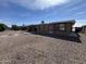 Rear view of home featuring concrete patio, a gravel yard and well maintained property at 4530 E Dragoon Ave, Mesa, AZ 85206