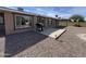 Wide shot of backyard featuring concrete patio, landscaping gravel, and stainless steel BBQ grill at 4530 E Dragoon Ave, Mesa, AZ 85206