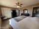 A bedroom features a ceiling fan, carpet, with a large dresser and wardrobe at 4530 E Dragoon Ave, Mesa, AZ 85206