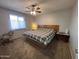 Bedroom featuring ceiling fan, carpet, and a large window at 4530 E Dragoon Ave, Mesa, AZ 85206