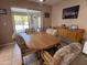 Comfortable dining room featuring wood table with upholstered chairs and a sliding glass door to the patio at 4530 E Dragoon Ave, Mesa, AZ 85206