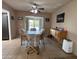 Cozy dining area with tile flooring, a ceiling fan, and sliding glass doors to the outside patio at 4530 E Dragoon Ave, Mesa, AZ 85206