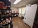 Storage room featuring vinyl floors, a refrigerator, shelving, and a utility table at 4530 E Dragoon Ave, Mesa, AZ 85206