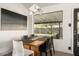 Modern dining room features a rustic wood table, sleek chairs, and a large window with a view of the backyard at 4530 N 9Th Ave, Phoenix, AZ 85013