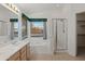 Bright bathroom featuring a double sink vanity, garden tub with window view, and a glass shower enclosure at 4625 E Thorn Tree Dr, Cave Creek, AZ 85331