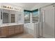 Bathroom with a double sink vanity, soaking tub under a window, and glass-enclosed shower at 4625 E Thorn Tree Dr, Cave Creek, AZ 85331