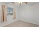 Bedroom featuring a ceiling fan, window, and neutral carpet at 4625 E Thorn Tree Dr, Cave Creek, AZ 85331