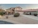 Inviting tan stucco home featuring a tile roof, desert landscaping, and an attached two-car garage at 4625 E Thorn Tree Dr, Cave Creek, AZ 85331