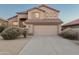 Inviting tan stucco home featuring a tile roof, desert landscaping, and an attached two-car garage at 4625 E Thorn Tree Dr, Cave Creek, AZ 85331