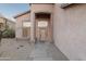 Inviting covered front entrance to a tan stucco home featuring a tile roof and desert landscaping at 4625 E Thorn Tree Dr, Cave Creek, AZ 85331