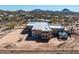 Aerial view of a desert home featuring a fenced-in backyard with a dining area and greenhouse at 50408 N 22Nd Ave, New River, AZ 85087