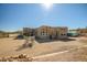 Desert home featuring an outdoor dining area and greenhouse in a spacious backyard at 50408 N 22Nd Ave, New River, AZ 85087