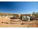 Desert home featuring an outdoor dining area and greenhouse set against a mountain backdrop at 50408 N 22Nd Ave, New River, AZ 85087