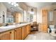 Well-lit bathroom with double sinks, vanity area, and storage cabinets at 50408 N 22Nd Ave, New River, AZ 85087