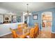 Elegant dining room featuring a glass-top table with seating for six and modern light fixture at 50408 N 22Nd Ave, New River, AZ 85087