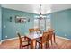 Light filled dining room with wood floors, a large window overlooking the exterior, and stylish furnishings at 50408 N 22Nd Ave, New River, AZ 85087