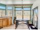 Sunlit breakfast nook in the kitchen featuring a classic light fixture and expansive window views at 50408 N 22Nd Ave, New River, AZ 85087