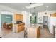 Open kitchen design featuring an island with seating, wood cabinets, and a view into the dining area at 50408 N 22Nd Ave, New River, AZ 85087