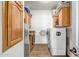 Functional laundry room with ample cabinetry, washer, and dryer at 50408 N 22Nd Ave, New River, AZ 85087