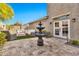 Backyard seating area includes an outdoor sofa, outdoor chairs, and a water fountain for relaxing and entertaining at 5110 S Sandstone St, Gilbert, AZ 85298