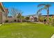 Backyard showcases artificial grass and hammock strung between palm trees, a lovely outdoor oasis at 5110 S Sandstone St, Gilbert, AZ 85298