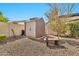 Backyard shed, concrete bench, and landscaping with rock provide a tranquil outdoor space at 5110 S Sandstone St, Gilbert, AZ 85298