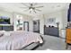 This bedroom features tile floors, a ceiling fan and access to the bathroom and other rooms at 5110 S Sandstone St, Gilbert, AZ 85298