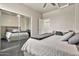 Bedroom with a bed with light gray bedding, mirrored closet doors, and a ceiling fan at 5110 S Sandstone St, Gilbert, AZ 85298