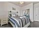 Bedroom featuring a bed with gray and white patterned bedding, end table, and a mirrored closet at 5110 S Sandstone St, Gilbert, AZ 85298