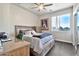 Bedroom with platform bed, side table, and a corner desk space bathed in natural light at 5110 S Sandstone St, Gilbert, AZ 85298