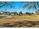 A neighborhood community showcasing lawn, homes, and clear blue skies on a sunny day at 5110 S Sandstone St, Gilbert, AZ 85298