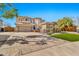 Stunning two-story home boasts a spacious driveway, lush landscaping, and charming curb appeal for modern living at 5110 S Sandstone St, Gilbert, AZ 85298