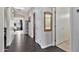 Hallway featuring an ornate mirror, and gray hardwood floors, providing a glimpse into other rooms at 5110 S Sandstone St, Gilbert, AZ 85298