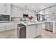 Bright kitchen featuring white cabinets, a center island, stainless steel appliances, and stylish finishes at 5110 S Sandstone St, Gilbert, AZ 85298