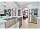 Modern kitchen with stainless steel appliances, white countertops, and an island sink with view into other rooms at 5110 S Sandstone St, Gilbert, AZ 85298