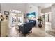 Bright living room featuring tile floors, neutral paint, beachy artwork, and French doors offering plenty of natural light at 5110 S Sandstone St, Gilbert, AZ 85298