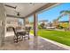 Spacious covered patio featuring modern furniture, ceiling fans, and a view of the lush backyard at 5110 S Sandstone St, Gilbert, AZ 85298