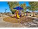 A neighborhood playground on a circular mulch bed offers a fun and safe play area at 5110 S Sandstone St, Gilbert, AZ 85298