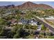 Beautiful home exterior featuring mature trees, manicured landscaping, a long driveway, and mountain views at 5144 E Calle Del Medio --, Phoenix, AZ 85018