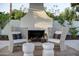 Outdoor fireplace with comfortable seating, lantern, and decorative pillows at 5144 E Calle Del Medio --, Phoenix, AZ 85018