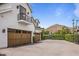 Exterior view of the garage with wood doors, driveway, and desert mountain views at 5144 E Calle Del Medio --, Phoenix, AZ 85018