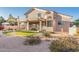 Landscaped backyard with artificial grass, desert plants, and a covered patio ideal for outdoor entertaining at 5545 E Helena Dr, Scottsdale, AZ 85254