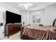 Bedroom with a large flat-screen TV, shuttered window, and ceiling fan at 5545 E Helena Dr, Scottsdale, AZ 85254