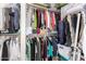 Walk-in closet with lots of hanging clothes and upper storage shelves at 5545 E Helena Dr, Scottsdale, AZ 85254